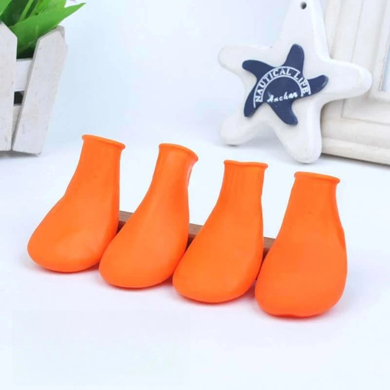 4 orange waterproof rubber dog boots for paw protection. Anti-slip, durable, and easy-fit shoes for small to large dogs.