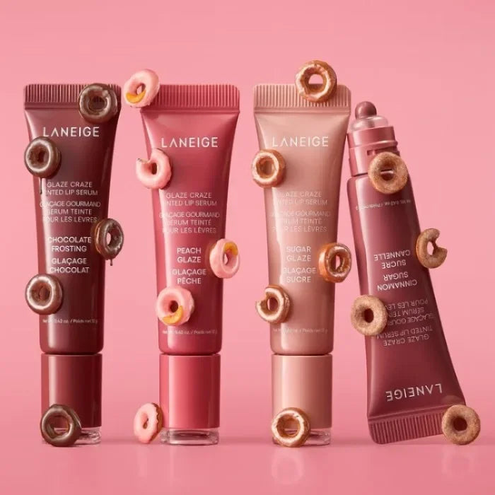 Laneige Glaze Craze Tinted Lip Serum tubes with donut-themed aesthetic in various shades on a pink background.