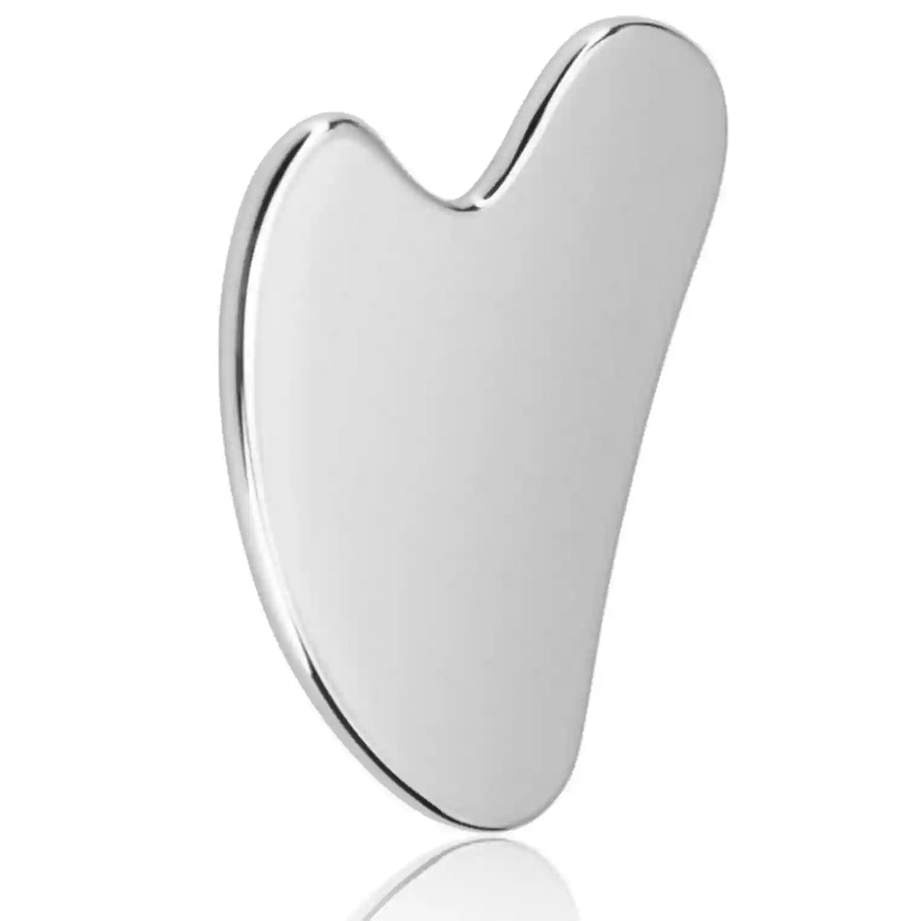 Smooth, heart-shaped stainless steel Gua Sha facial tool with a reflective silver finish.
