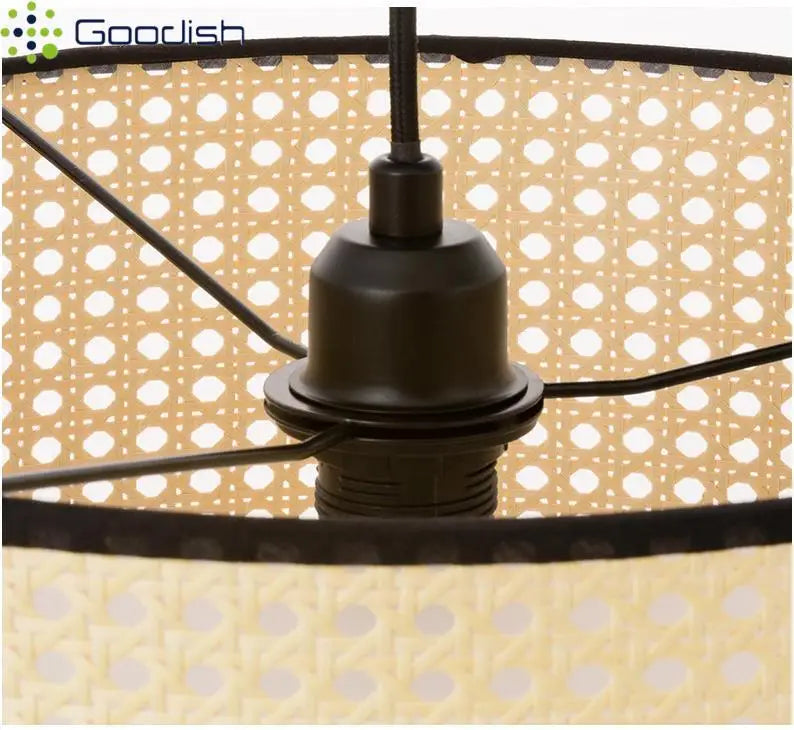 Cylindrical rattan pendant light shade with a woven mesh pattern, black metal frame, and central socket fixture.