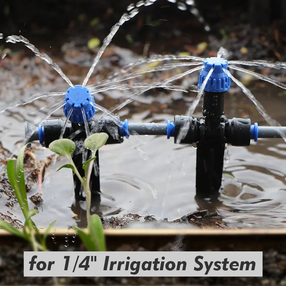 Multiple stake-mounted sprinklers with blue heads distributing water across a pond