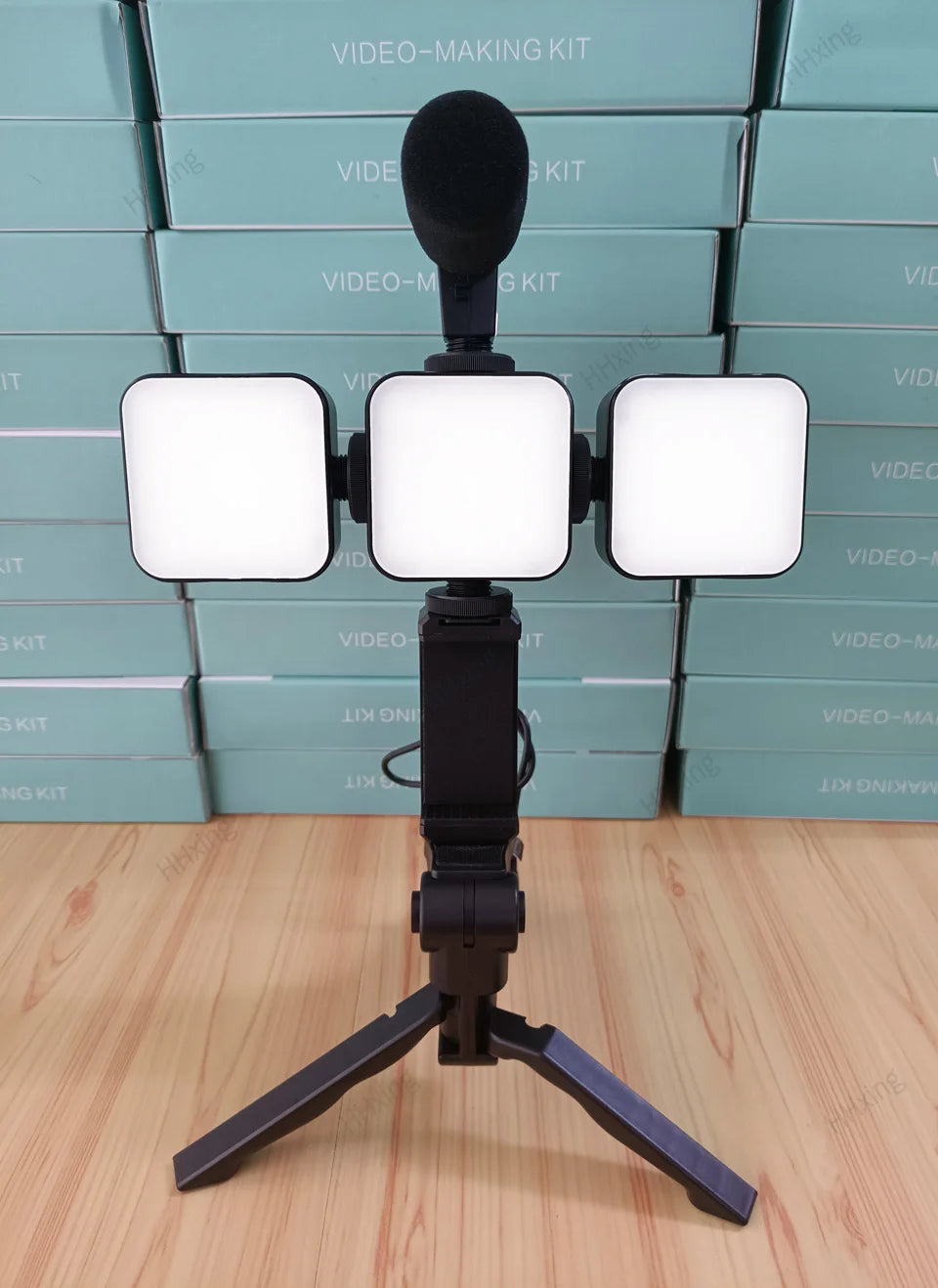 Video-making kit with three square LED lights, a black foam microphone, phone mount, and a folding tripod stand.