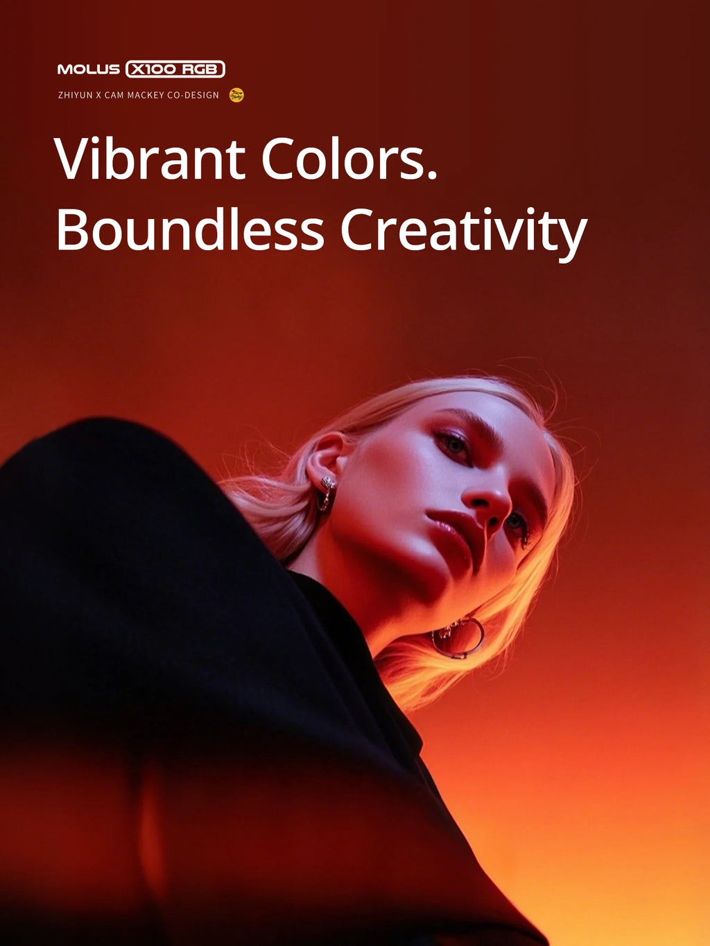 Molus X100 RGB compact LED light illuminating a woman’s face with vibrant orange and red tones for creative photography.