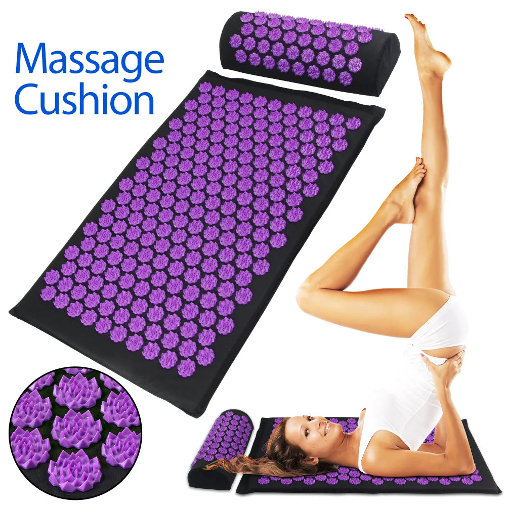 Black acupressure mat and pillow set with purple lotus-shaped plastic spikes, shown with a person using them.