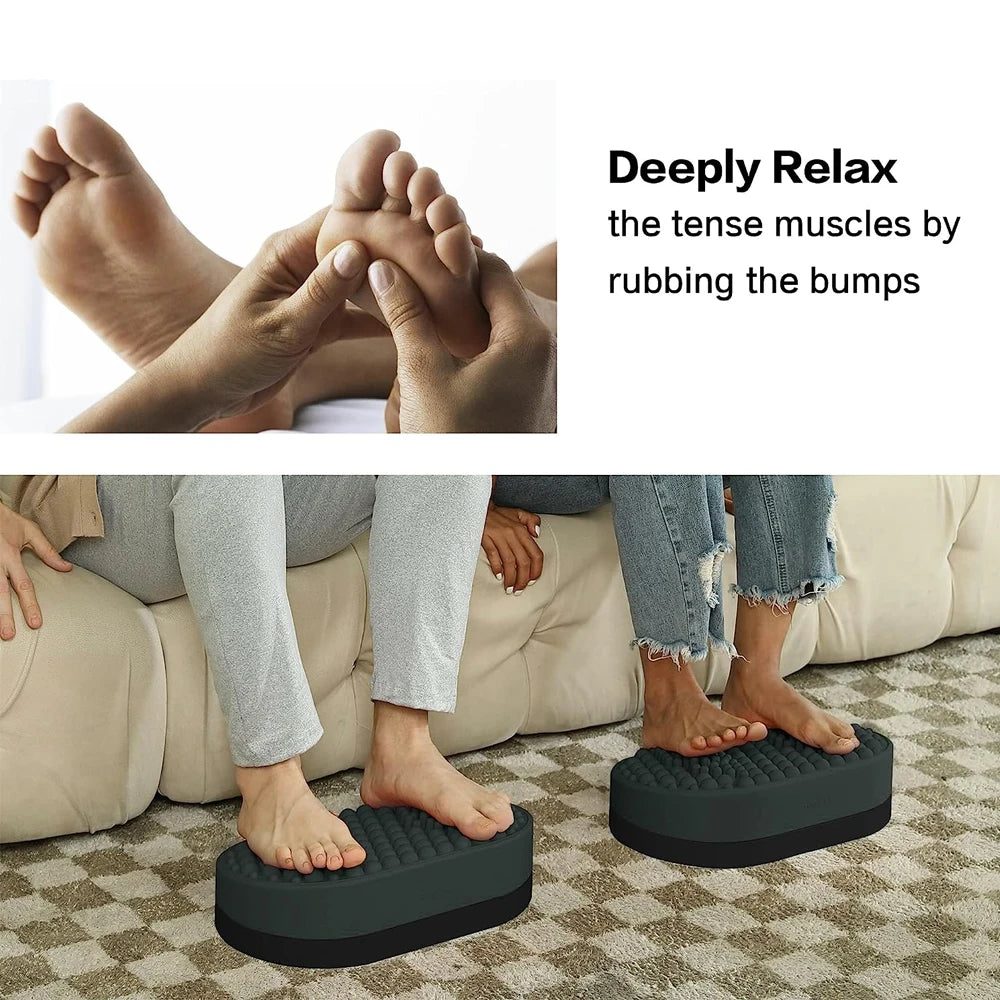 Grey ergonomic foot rest massager with textured surface for plantar fasciitis relief under desk or in home office.