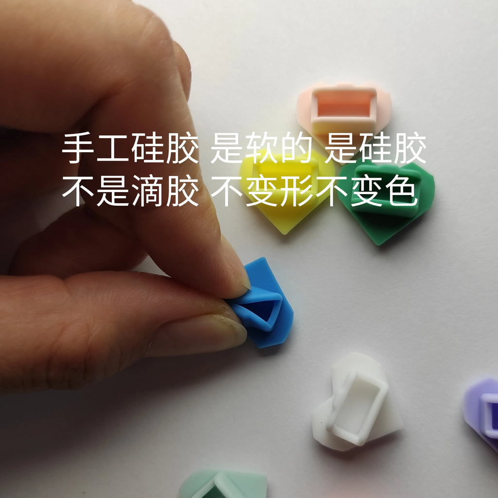 Colorful heart-shaped silicone dust plugs for Tamagotchi Uni, soft anti-deformation protective port covers.