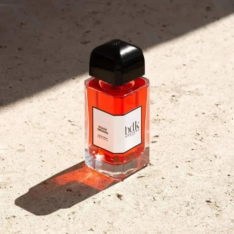 BDK Parfums Rouge Smoking 100ml EDP: Luxurious unisex fragrance in a square red glass bottle with a black cap.