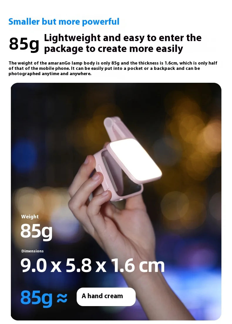 Compact, rectangular, light-pink portable LED photography light held in a hand for on-the-go illumination.