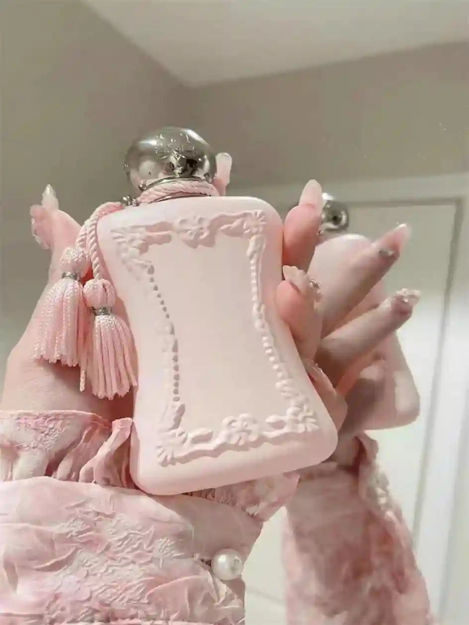 Luxury pink floral EDP perfume for women in ornate bottle with tassels. 75ml long-lasting pheromone fragrance spray.