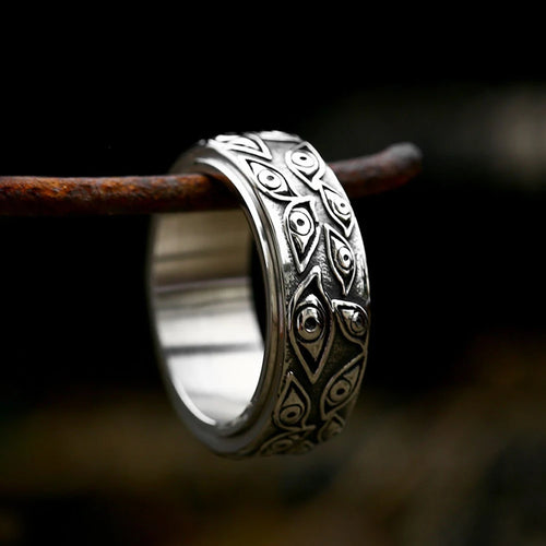Tidesmit silver stainless steel ring featuring an engraved, rotatable pattern of multiple demon eyes on a dark background.