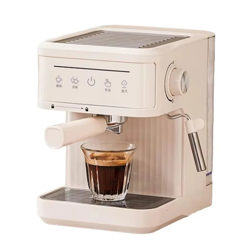 Compact white espresso machine with steam wand, touch control panel, and glass cup on a drip tray.