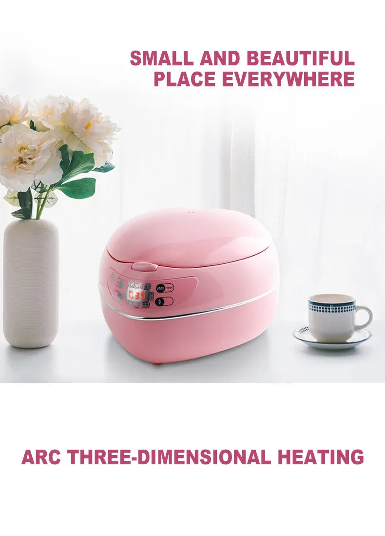 Pink heart-shaped rice cooker on table, front control panel visible