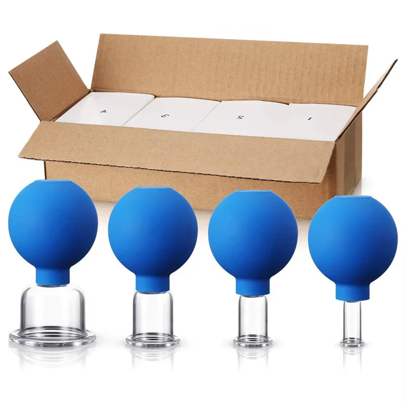 Four blue rubber facial cupping tools with varying sizes of clear glass suction bases in front of a cardboard box.