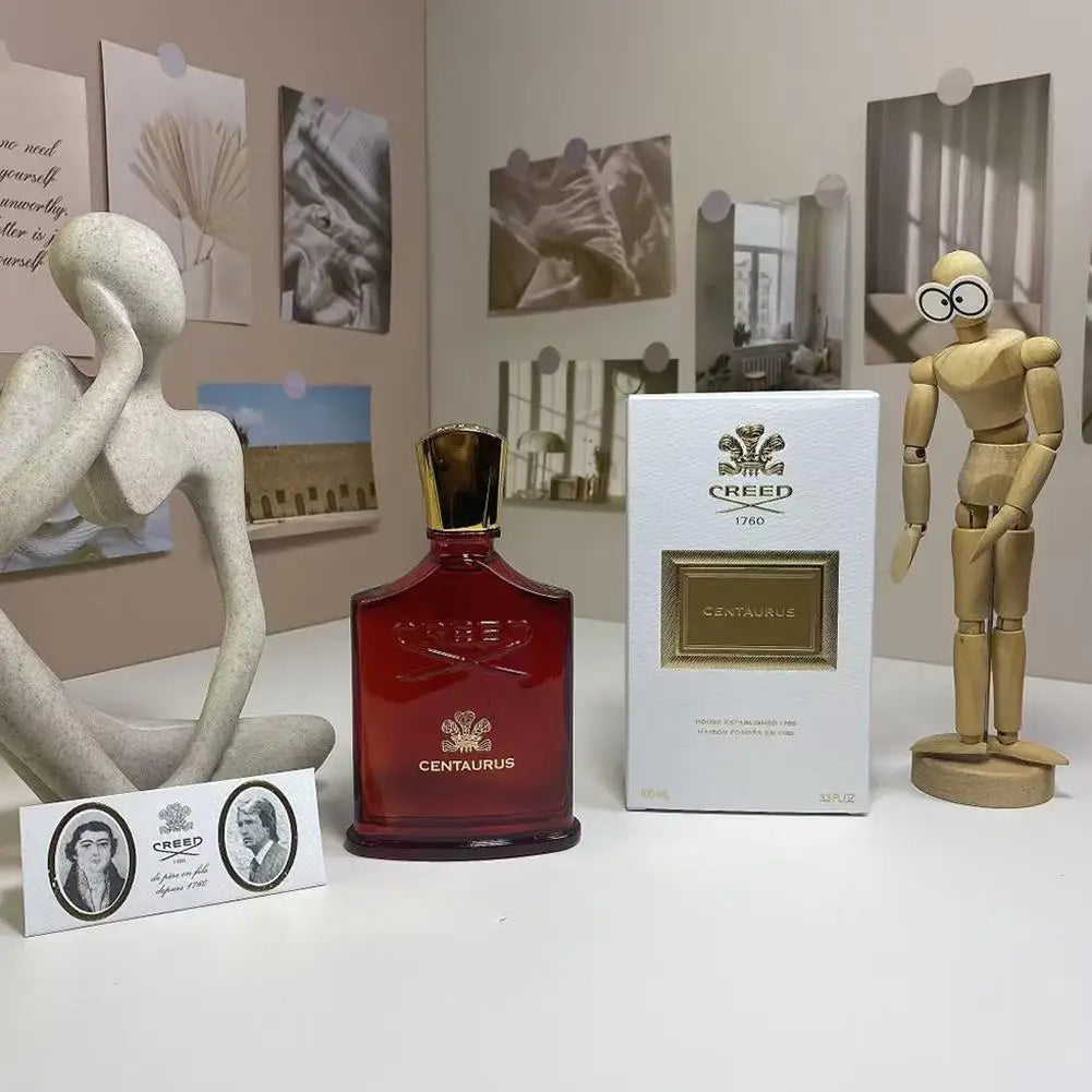 Creed Centaurus perfume, 100ml. Dark red glass bottle with gold cap and matching white box for men’s fragrance.