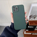 Matte dark green silicone phone case with a camera cutout, held in a hand for smartphone protection.
