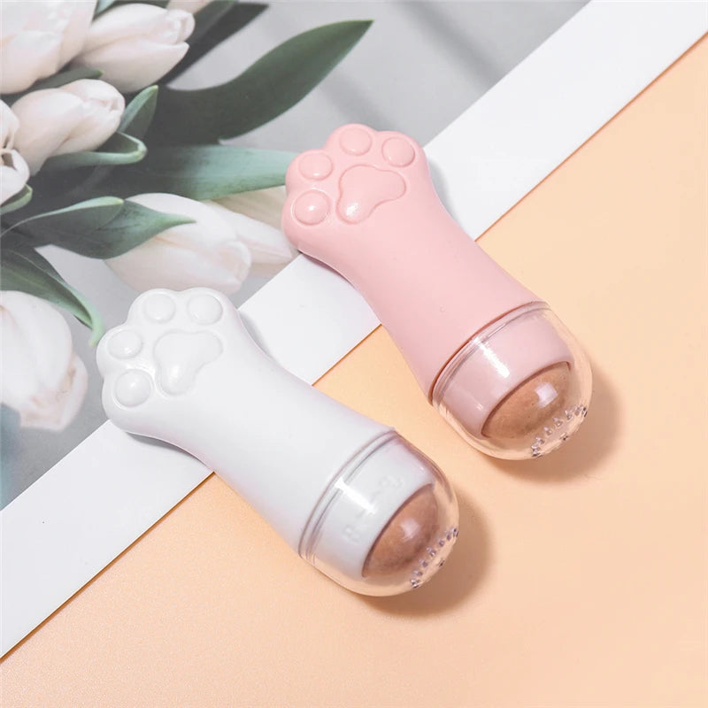Two cat-paw shaped oil-absorbing rollers with volcanic stone heads, in pastel pink and white.