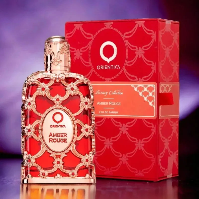 Orientica Amber Rouge 100ml EDP: Luxurious unisex fragrance in an ornate, gold-caged red glass bottle with gift box.