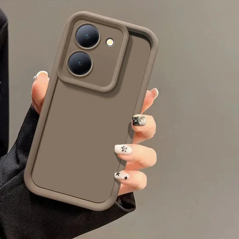 A hand holds a matte brown Tidesmit phone case for Poco M7 Pro with a raised, shockproof camera lens frame.