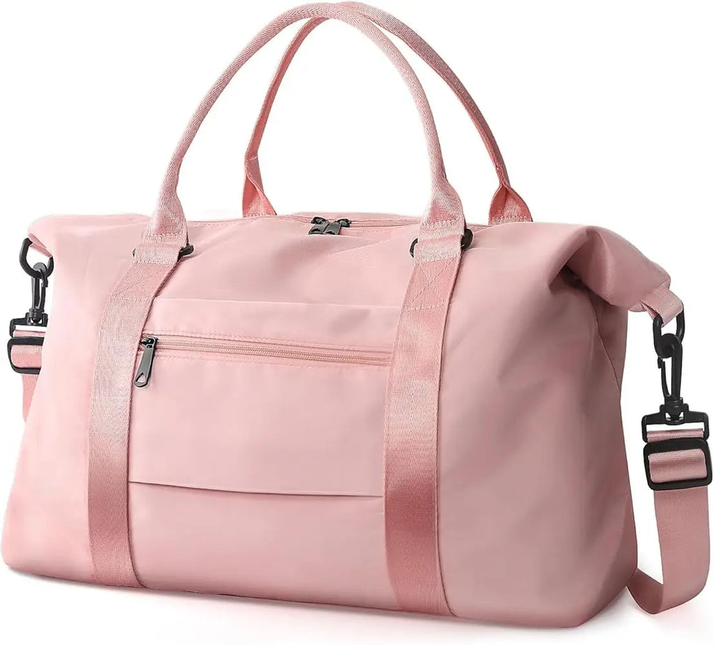 Large pink travel duffel bag with shoulder strap, durable fabric, zip pockets, and spacious compartment for gym or gear.