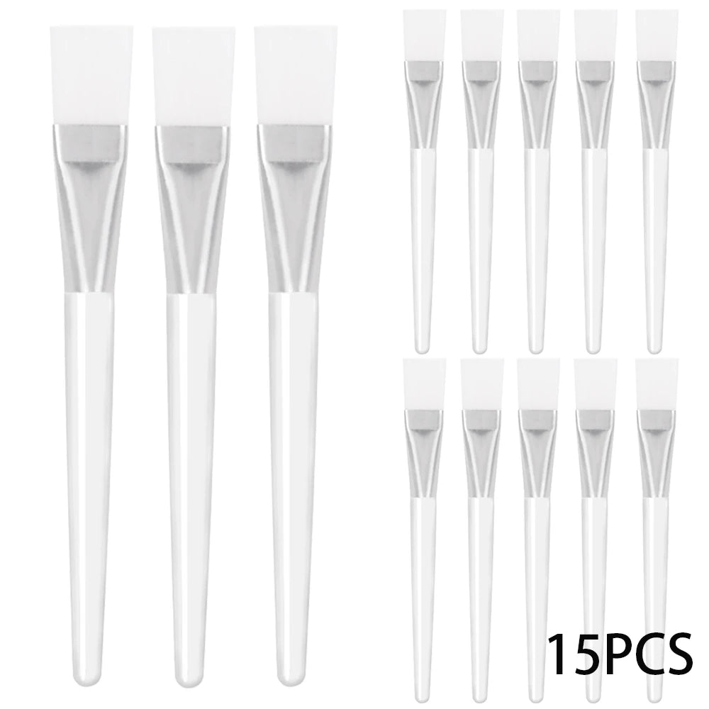 A set of 15 cosmetic facial mask brushes with white silicone heads, silver metal ferrules, and clear plastic handles.