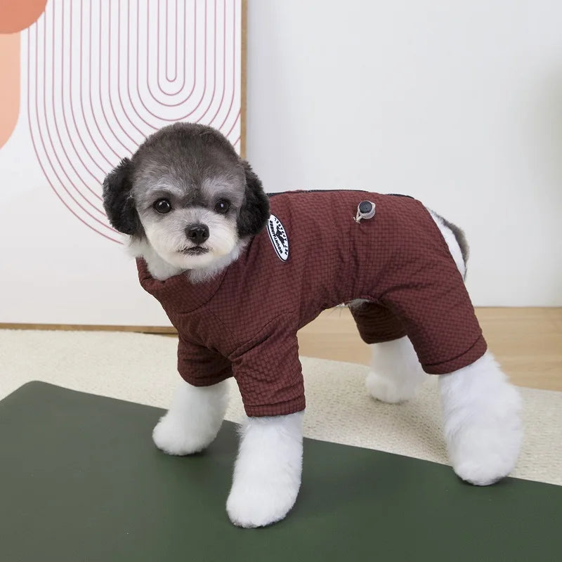 Small dog wearing a brown waterproof winter jumpsuit, providing warmth and comfort for puppies in cold weather.