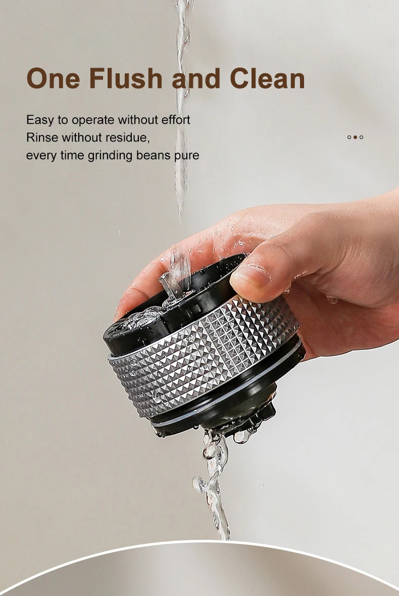Hand rinsing a compact black and silver metal coffee grinder component under water for easy cleaning.