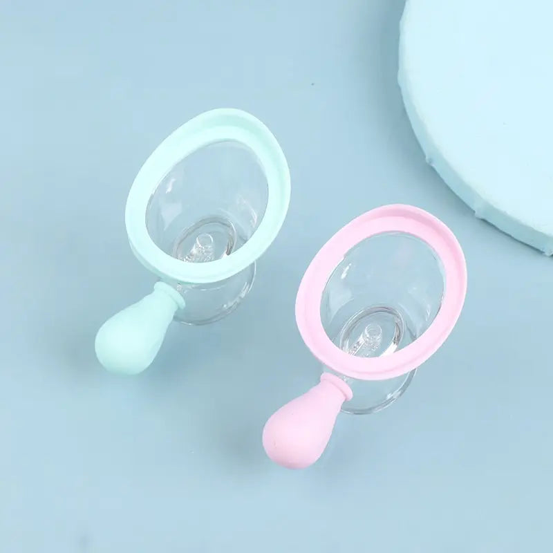Reusable soft silicone eye wash cups in pastel pink and mint green for eye cleaning and rinsing.