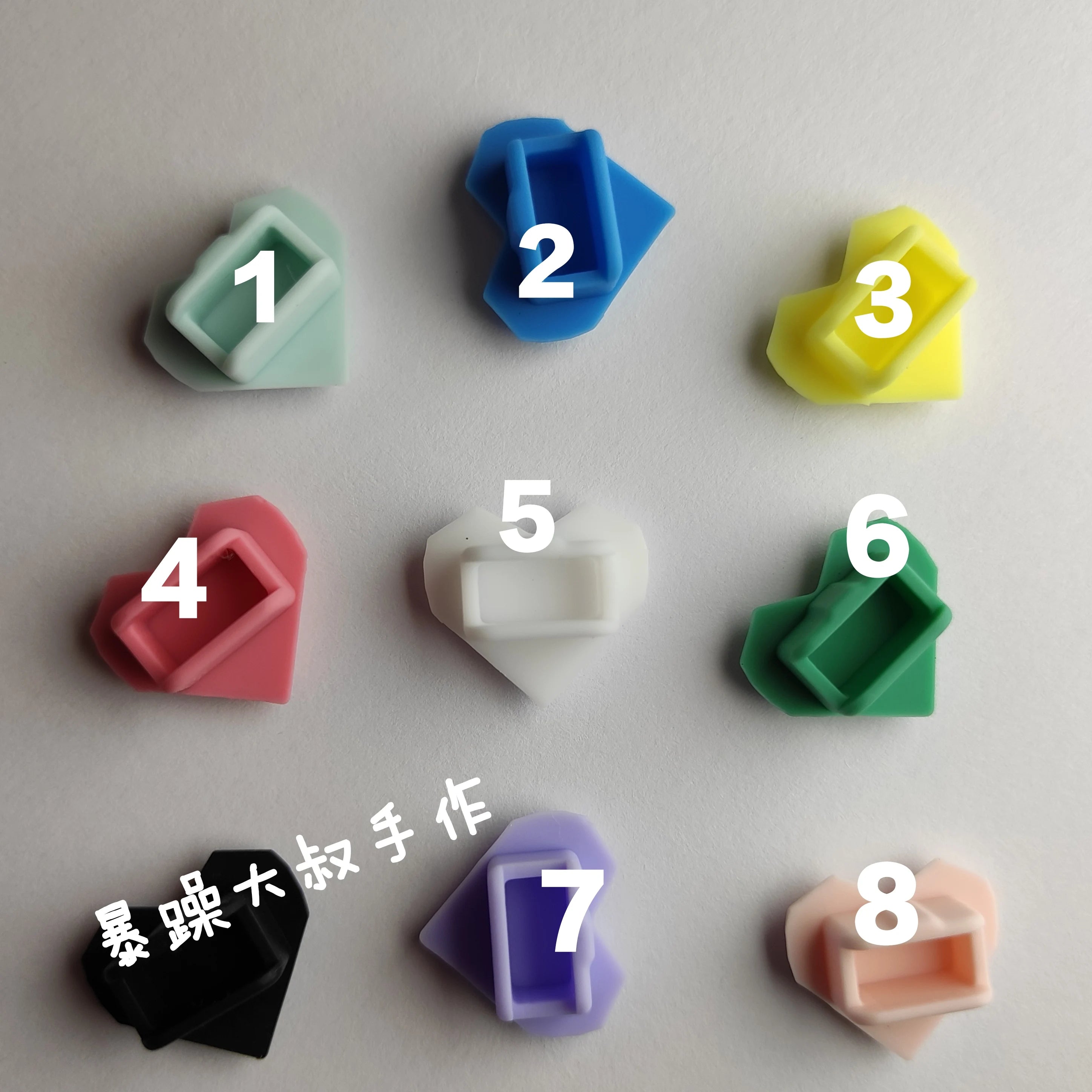 Colorful silicone heart dust plugs for Tamagotchi Uni to protect your electronic pet charging port from dirt.