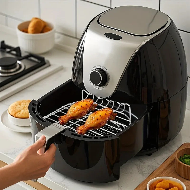 Air fryer with grill rack and skewers, showing chicken pieces in basket