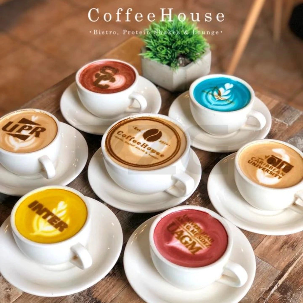 Set of white ceramic coffee cups with colorful lattes and brand logos from CoffeeHouse on a wooden table.