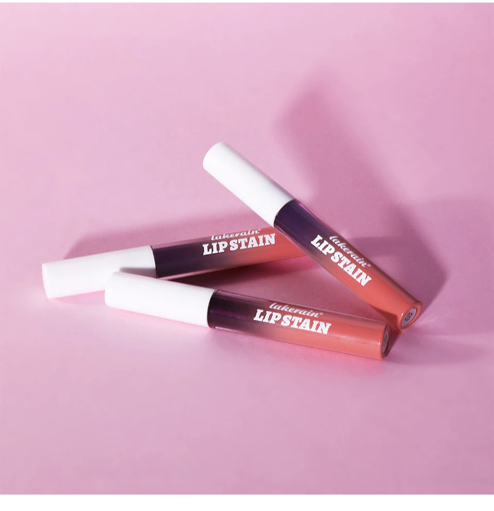 Three Lakerain waterproof peel-off lip stain tubes in pink tones with white caps on a soft pink background.