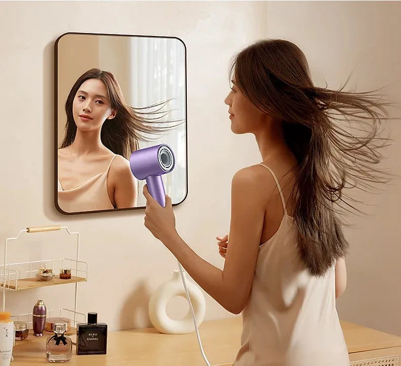Woman using purple 1600W high-speed anion hair dryer with LED display and nozzle for fast, smooth professional styling.