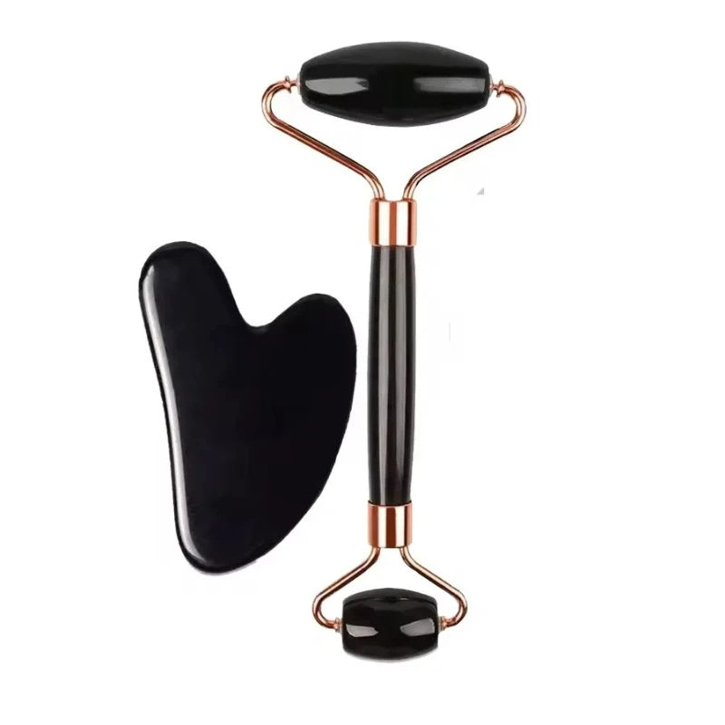 Black jade facial roller and matching gua sha tool with metallic rose gold accents on a white background.