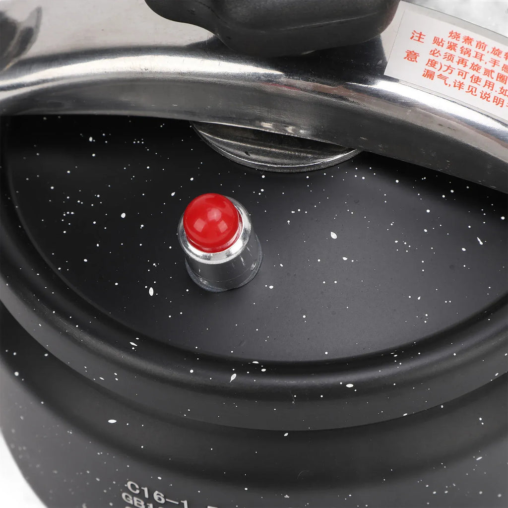 Black pressure canner lid with red safety indicator cap and pressure valve vent