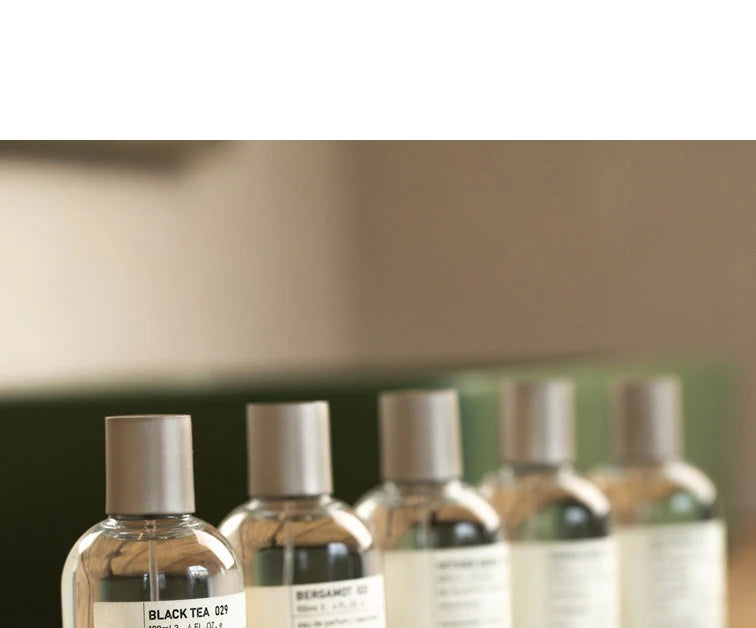 Unisex 100ml EDT, round glass bottle. Fresh, fruity, sandalwood fragrance. Minimalist design for everyday wear.