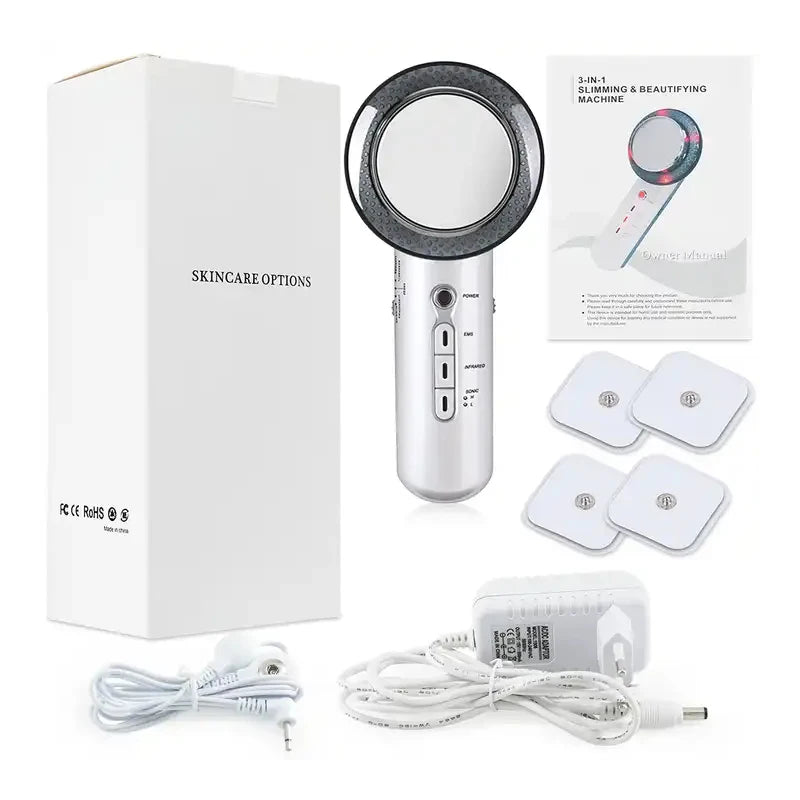 Silver 3-in-1 ultrasonic slimming device with manual, four EMS pads, power adapter, and white product box.