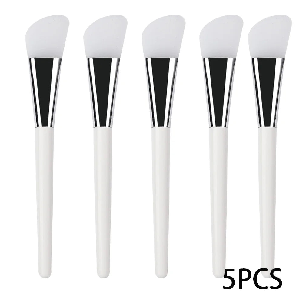 Five face mask brushes with soft white silicone spatula heads, silver ferrules, and white handles.