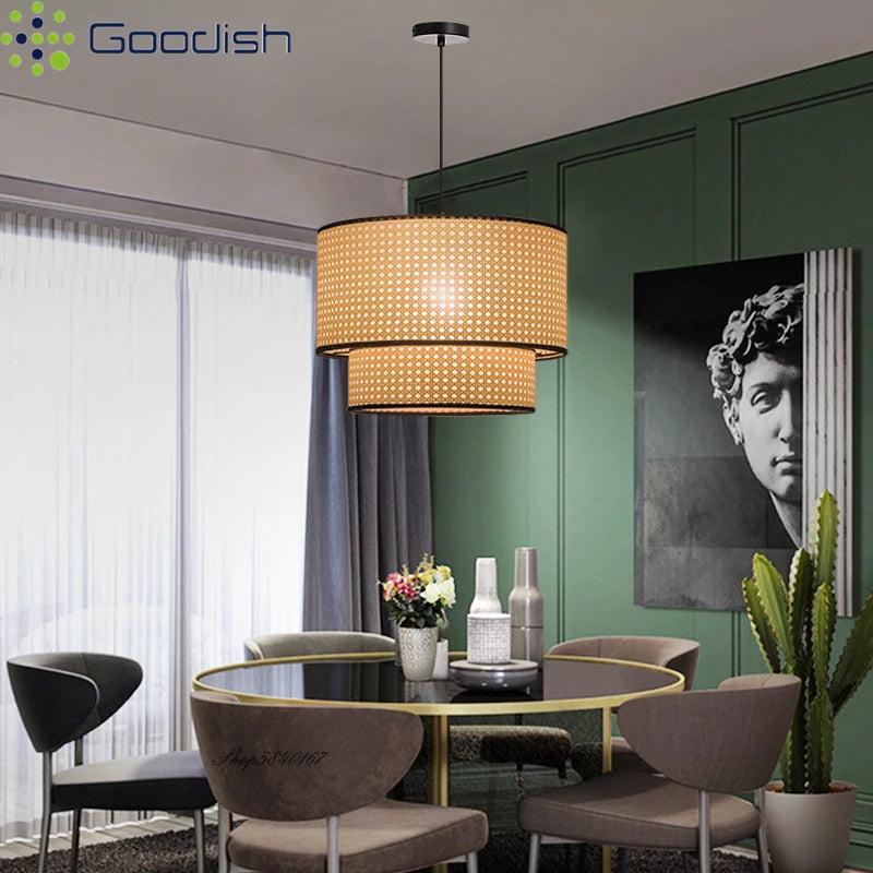 Two-tier drum pendant light with natural woven rattan shades and black trim for indoor dining room lighting.