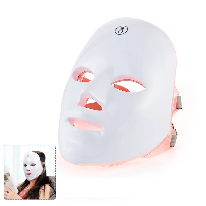 White, contoured LED facial mask with a touch-control icon, featuring a pink inner lining and an adjustable side strap.