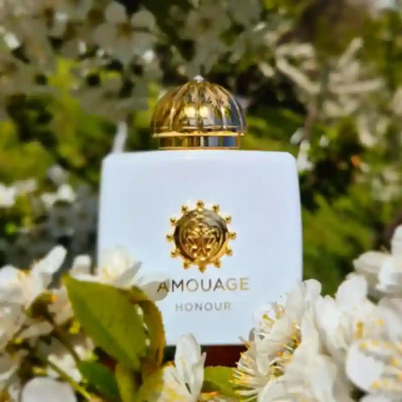 Amouage Honour 100ml women’s EDP: white square bottle, floral oriental scent, gold cap in a lush garden setting.