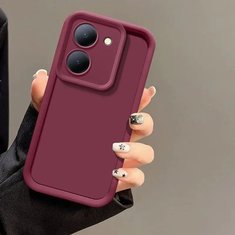 Hand holding a deep red, matte-finish Tidesmit shockproof case for Poco M7 Pro with a raised camera protection frame.