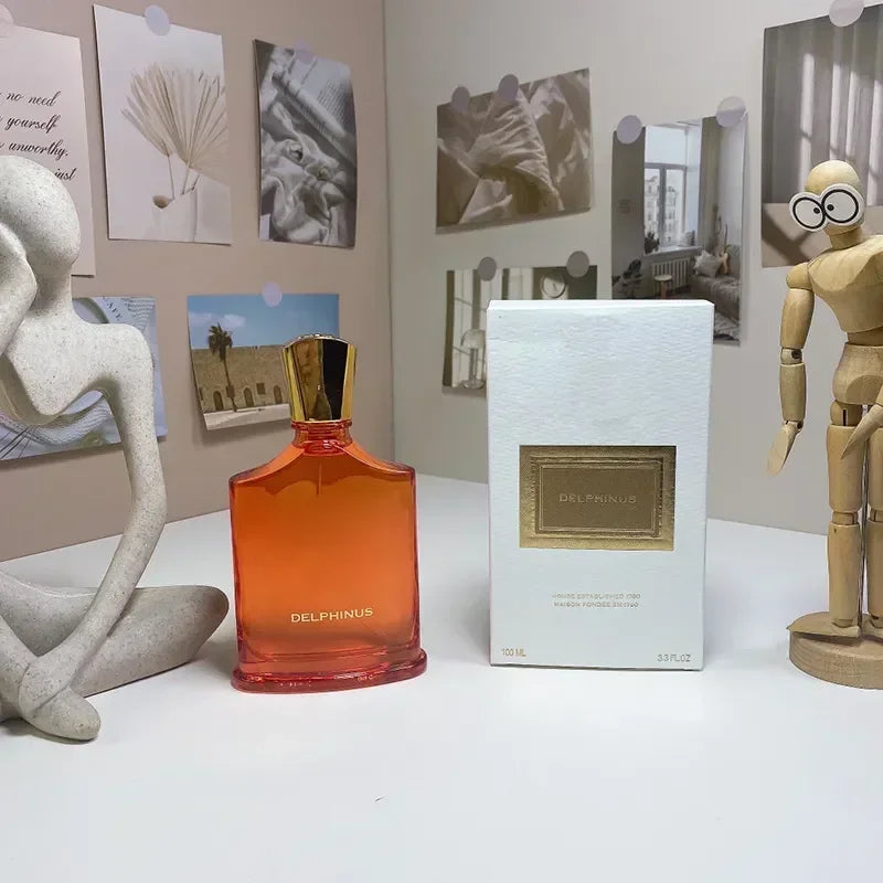Delphinus unisex EDP perfume in orange glass bottle with gold cap, luxury 100ml fragrance spray for men and women.