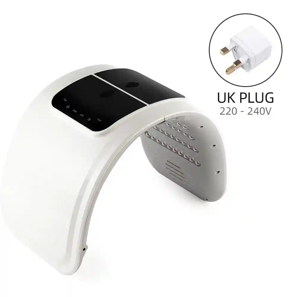 White, arched LED light therapy facial mask with black control panel and included UK power adapter.