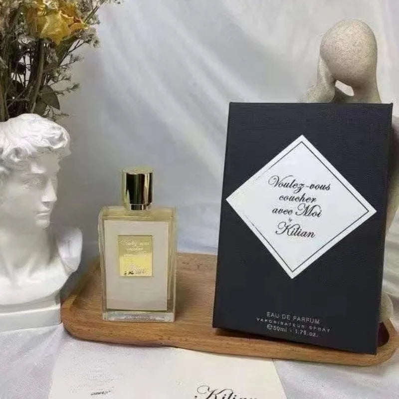 Kilian Voulez-Vous Coucher Avec Moi 50ml EDP: Unisex woody floral perfume in a sleek rectangular gold-capped bottle.