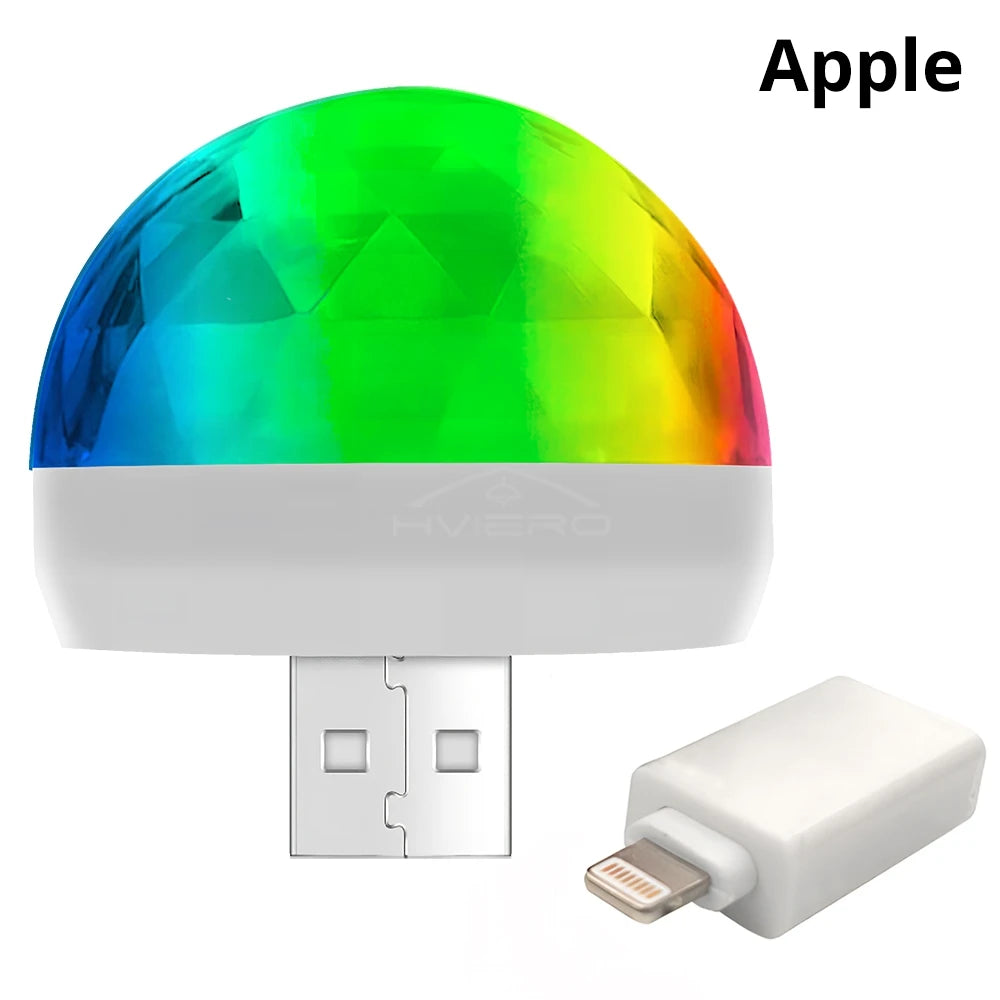 Small, dome-shaped multicolor disco light with USB connector and Lightning adapter for phone use.