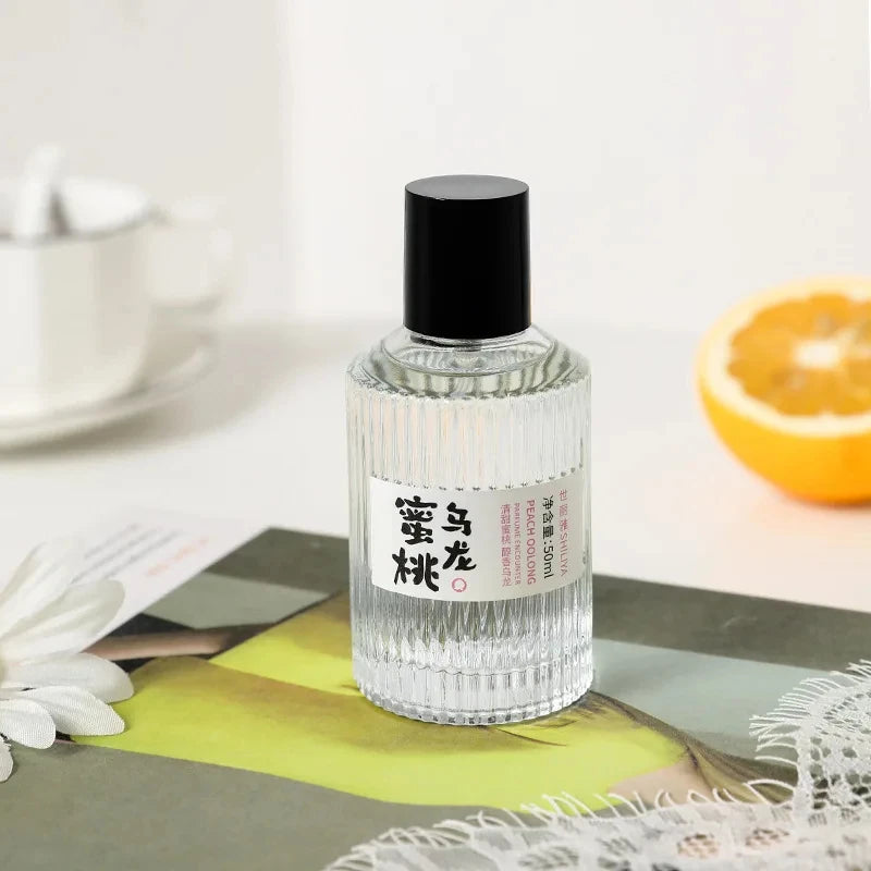 Shiliya Peach Oolong 50ml perfume. Elegant ribbed glass bottle, fresh fruity floral fragrance for women. Long-lasting.