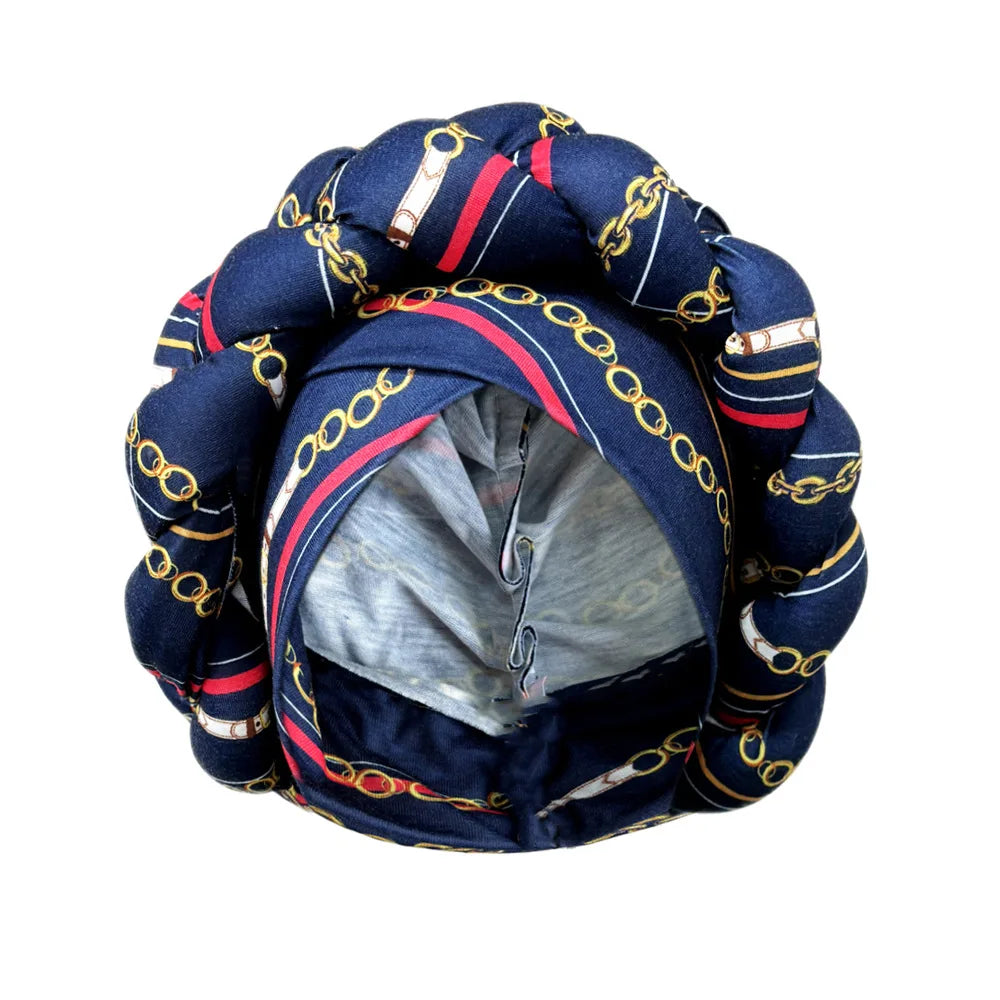 Tidesmit navy blue turban head wrap with a decorative gold chain print, featuring a thick, braided crown detail.