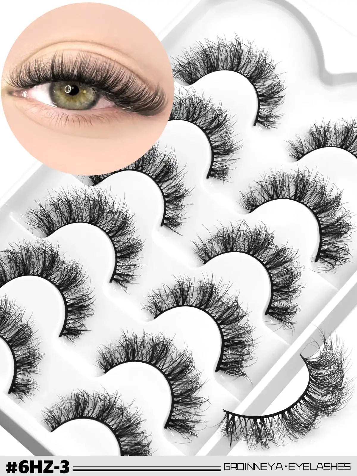 Fluffy black 3D mink false eyelashes in a wispy, cat-eye style set in a white storage tray, with an eye model inset.