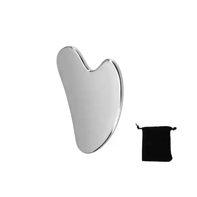 A polished silver stainless steel heart-shaped gua sha tool beside a small black drawstring storage pouch.