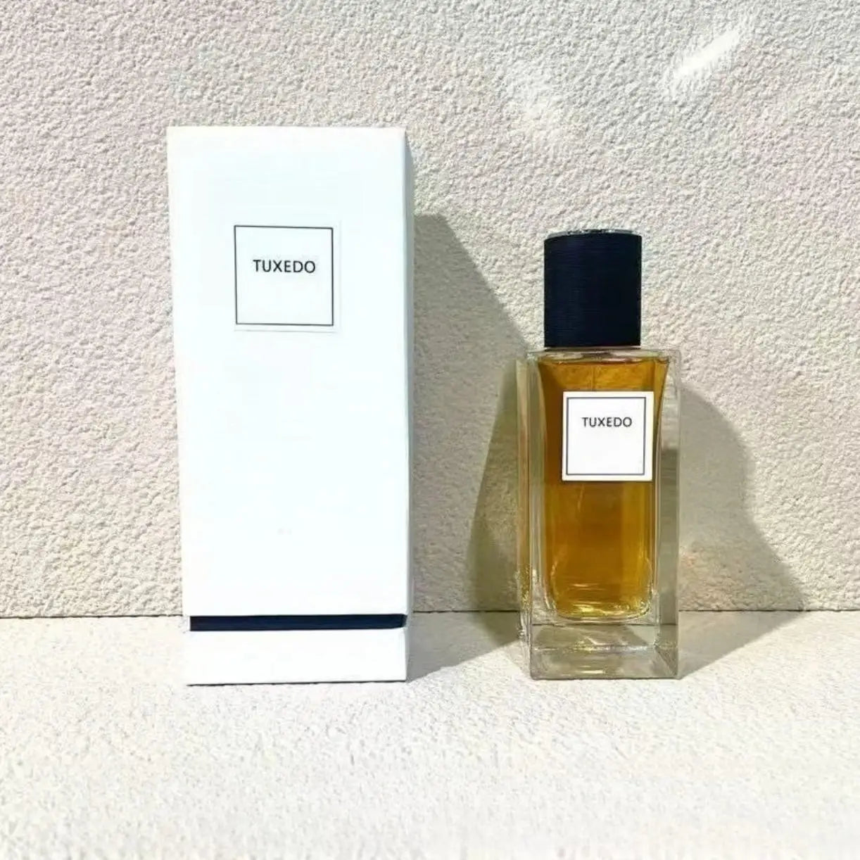 Tuxedo 125ml unisex oriental woody floral perfume. Rectangular glass bottle, black cap, long-lasting grapefruit scent.